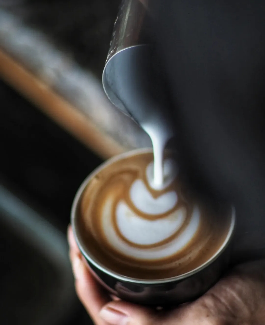 Milk being poured into espresso